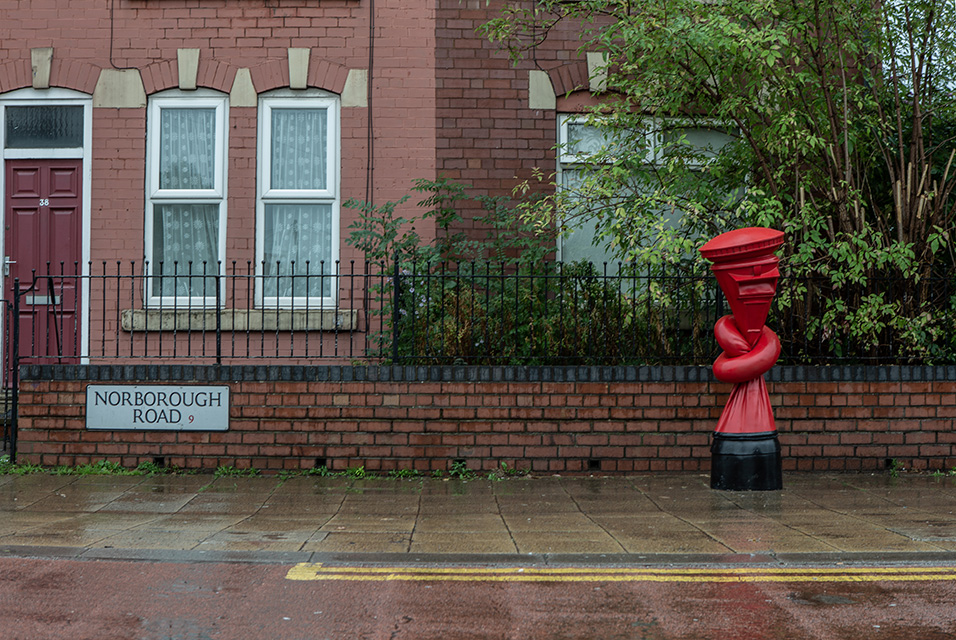 Artist Alex Chinneck ties post boxes in knots across the UK for his latest public artwork